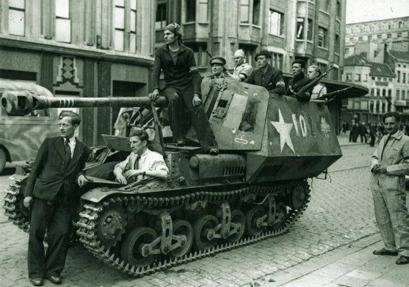 Miembros de la Resistencia belga posan con un tanque alemán en Amberes